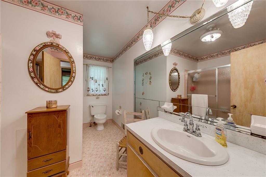 6223 Hulsey Road Clermont, GA 30527 - Photo 26 of 53 a bathroom with a toilet a double vanity sink and a mirror