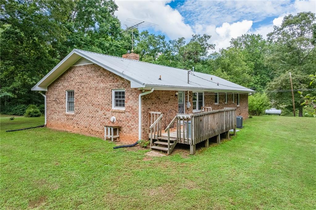 6223 Hulsey Road Clermont, GA 30527 - Photo 29 of 53 a view of a house with a yard and deck