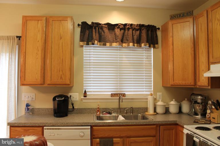 9 Boise Road Inwood, WV 25428 - Photo 1 of 30 a kitchen with a sink a refrigerator and cabinets
