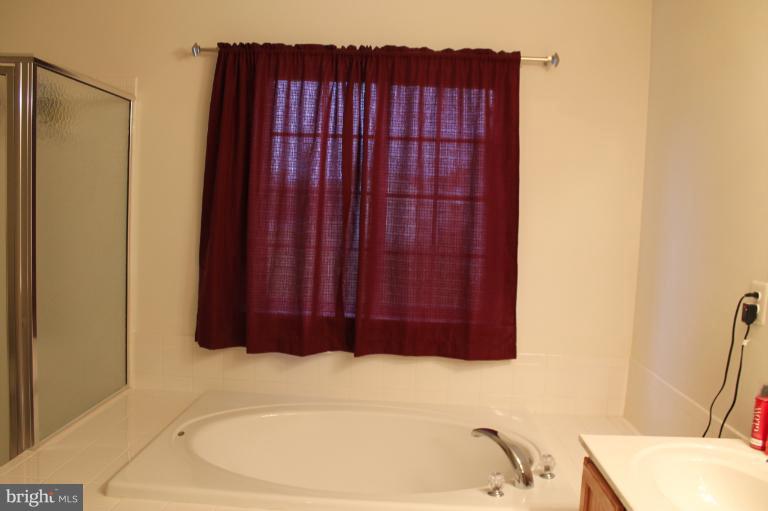 9 Boise Road Inwood, WV 25428 - Photo 22 of 30 a bathroom with a bathtub and shower