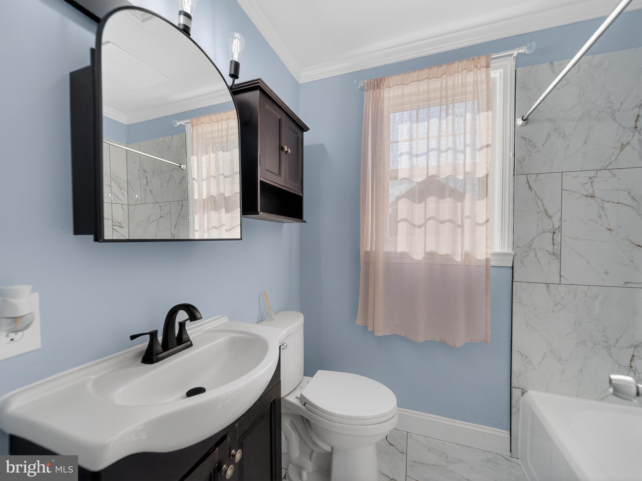 1815 Bonifant Road Silver Spring, MD 20906 - Photo 11 of 49 a bathroom with a sink toilet and a mirror