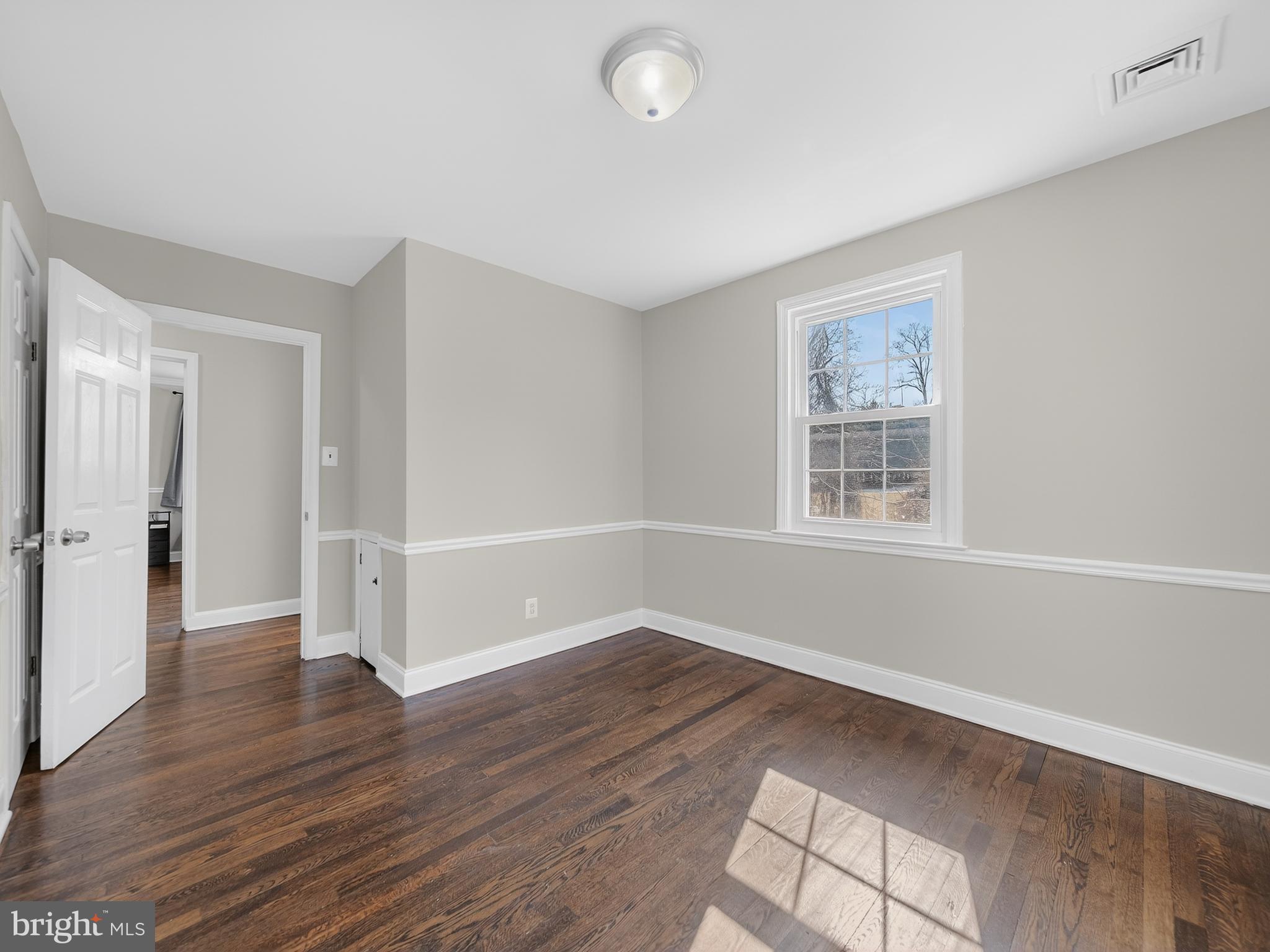 1815 Bonifant Road Silver Spring, MD 20906 - Photo 15 of 49 an empty room with wooden floor and windows