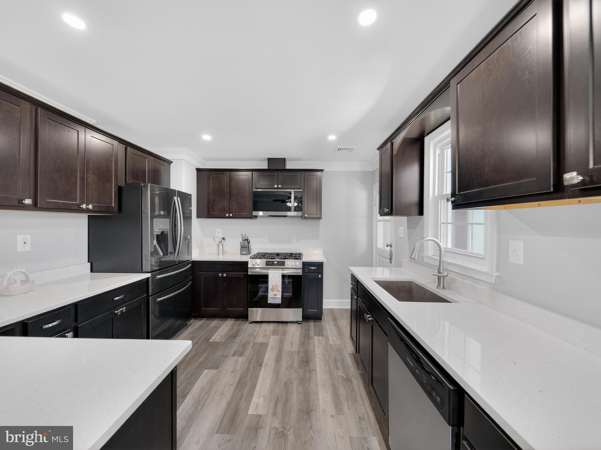 1815 Bonifant Road Silver Spring, MD 20906 - Photo 22 of 49 a large kitchen with stainless steel appliances kitchen island granite countertop a large counter top space a sink stainless steel appliances and cabinets