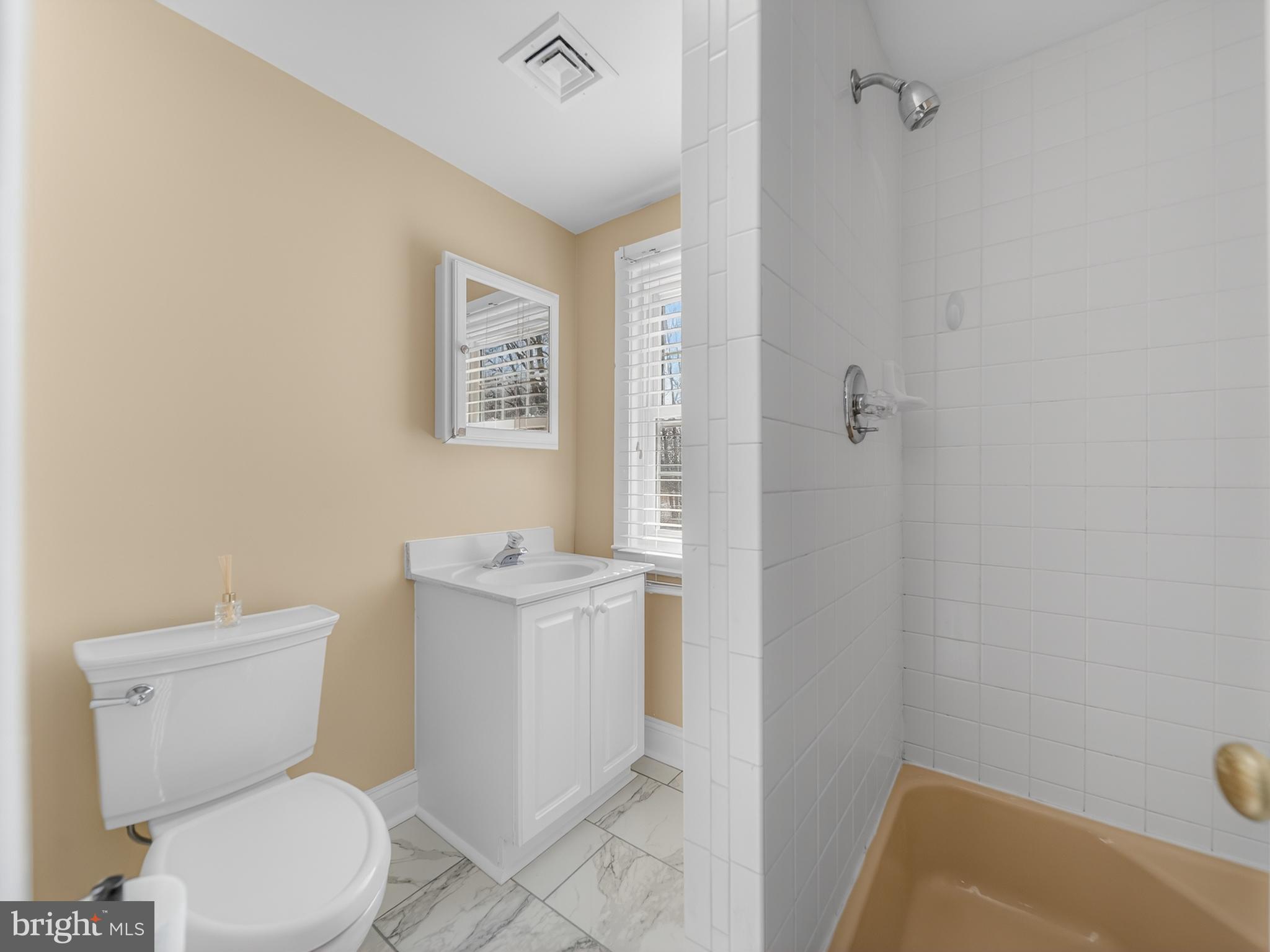 1815 Bonifant Road Silver Spring, MD 20906 - Photo 31 of 49 a white toilet sitting next to a bathroom sink