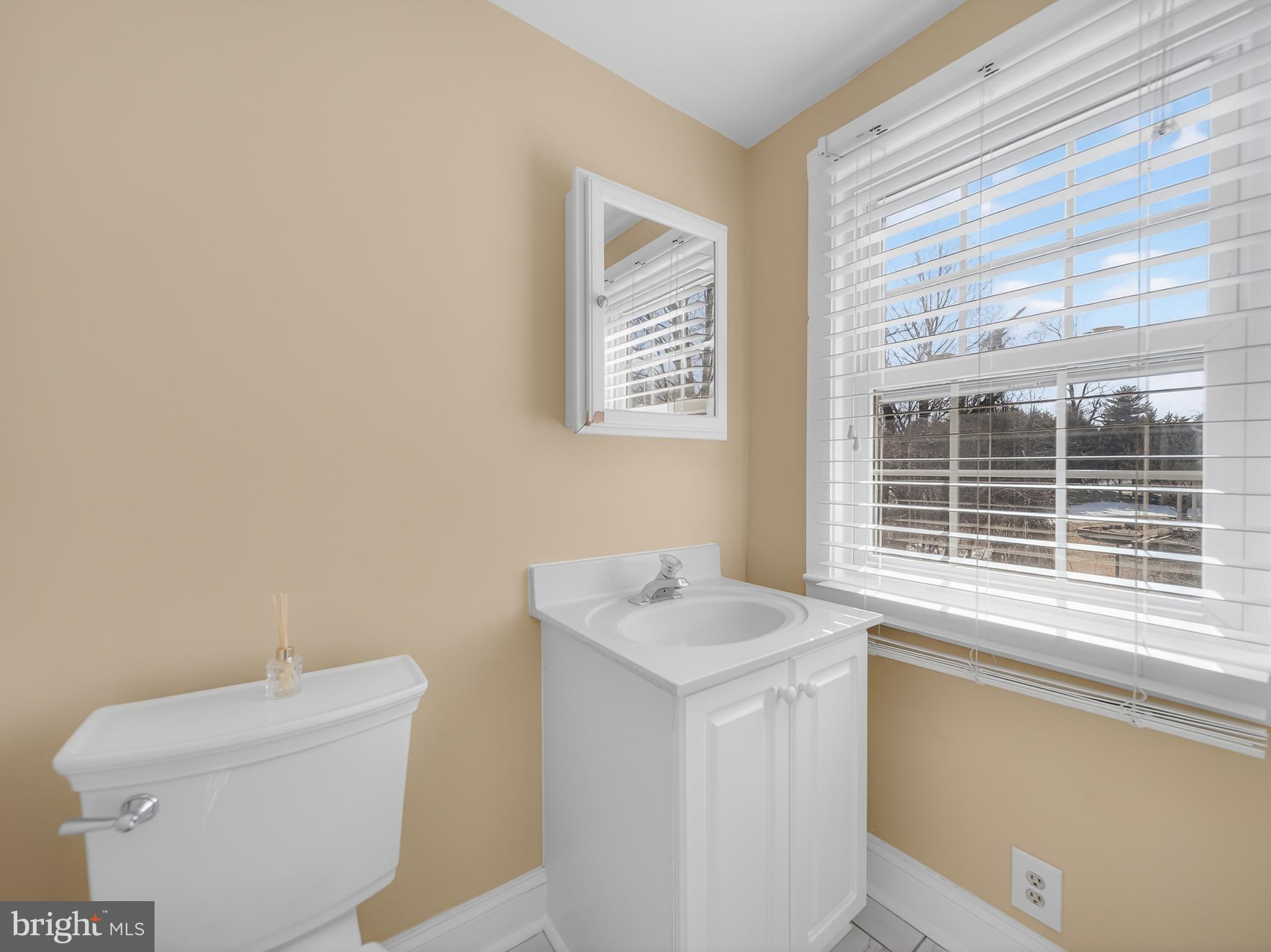 1815 Bonifant Road Silver Spring, MD 20906 - Photo 32 of 49 a bathroom with a sink a toilet and a window