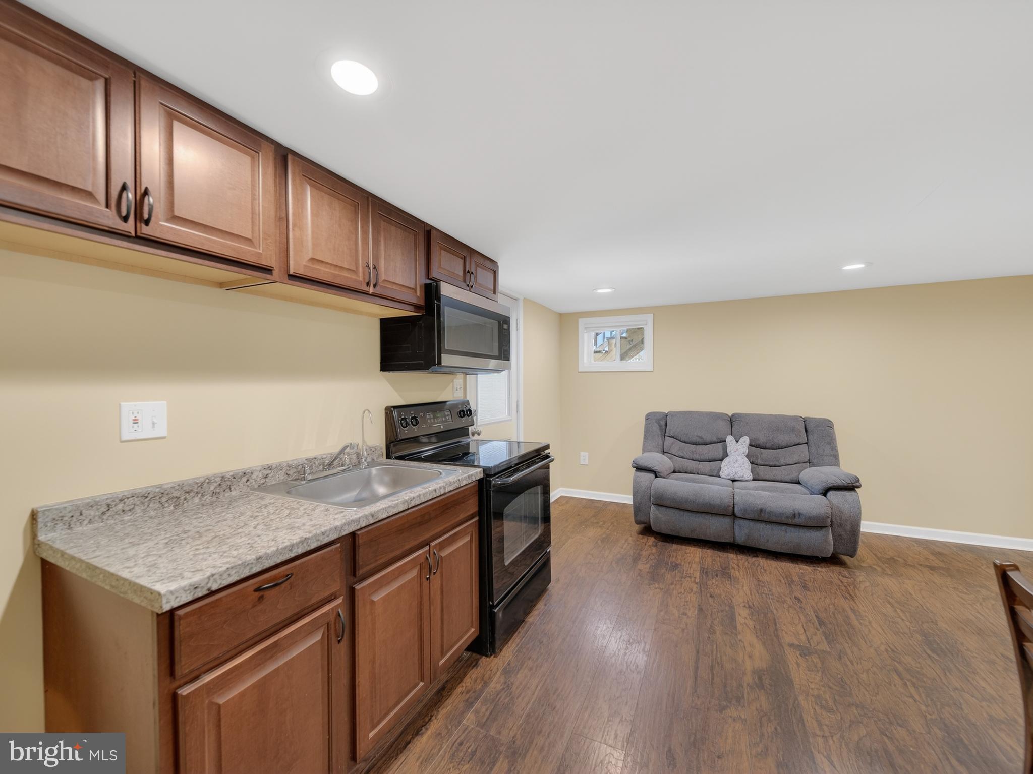 1815 Bonifant Road Silver Spring, MD 20906 - Photo 34 of 49 a kitchen with granite countertop a stove and a wooden floors