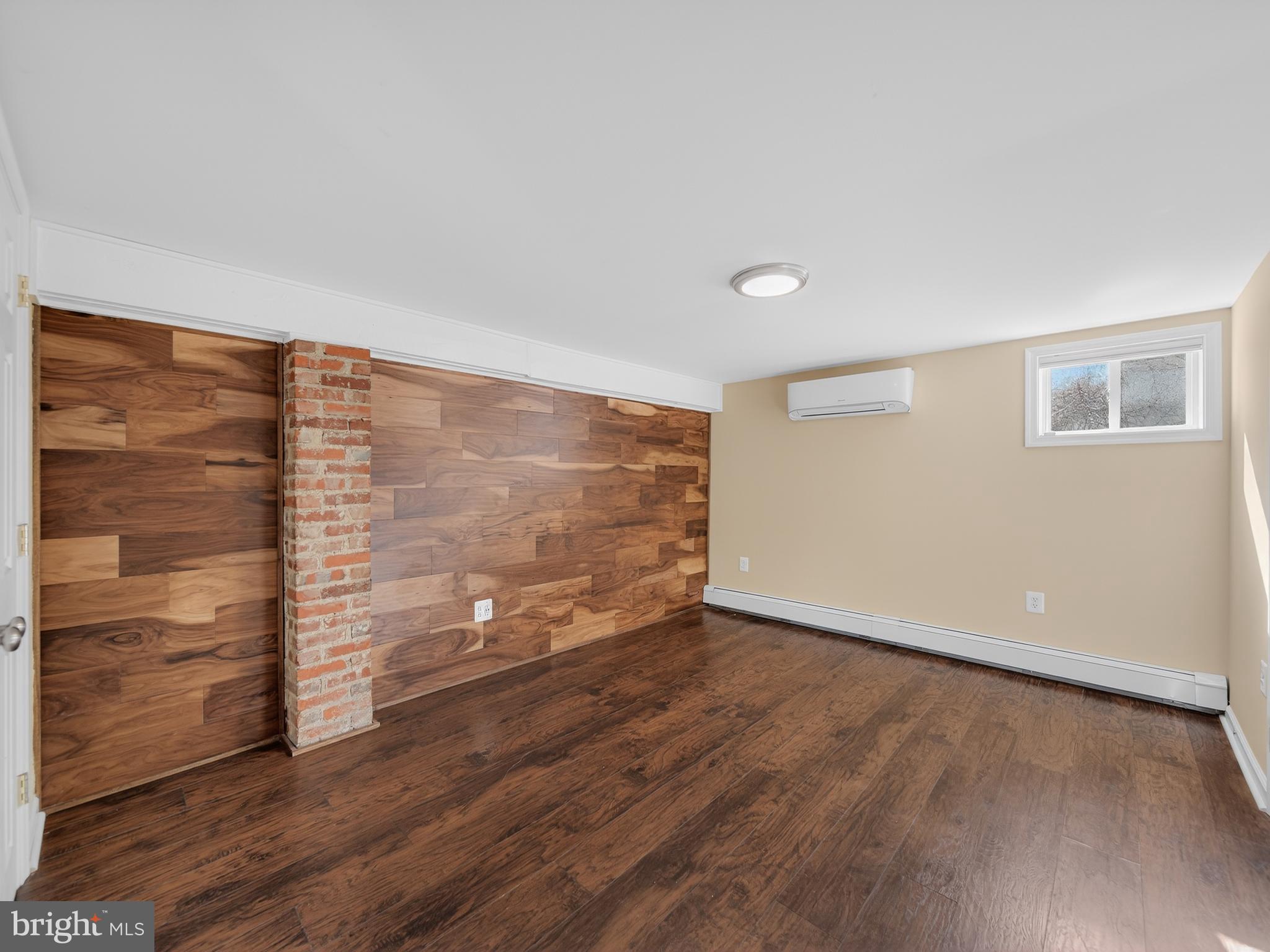 1815 Bonifant Road Silver Spring, MD 20906 - Photo 35 of 49 a view of an empty room with wooden floor and a window