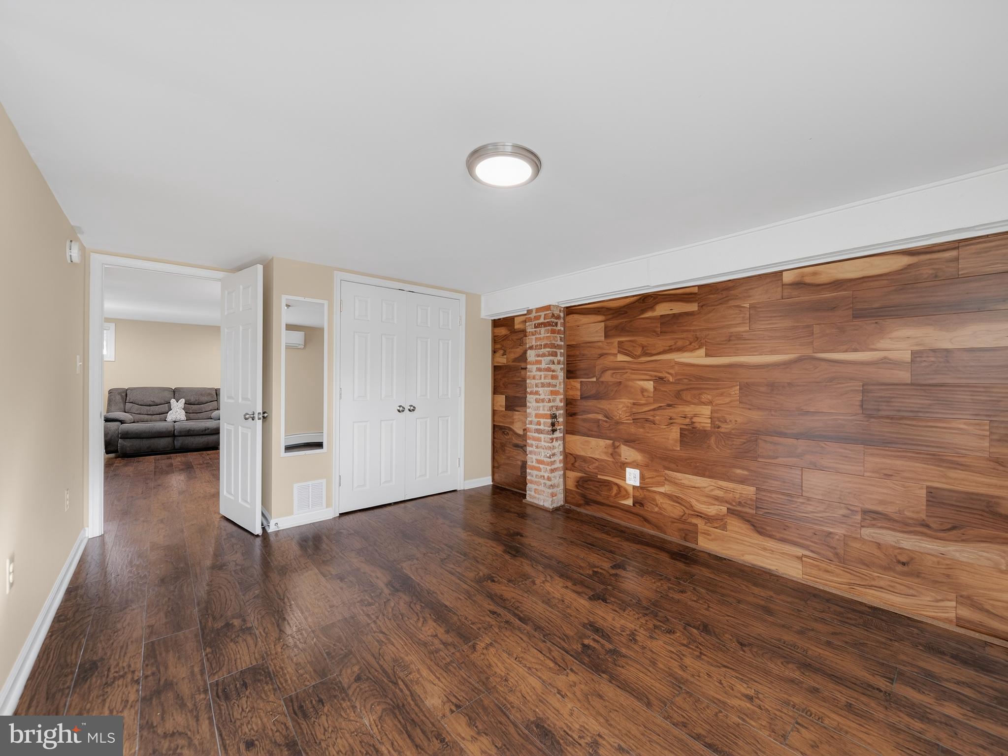 1815 Bonifant Road Silver Spring, MD 20906 - Photo 37 of 49 a view of empty room with wooden floor and window