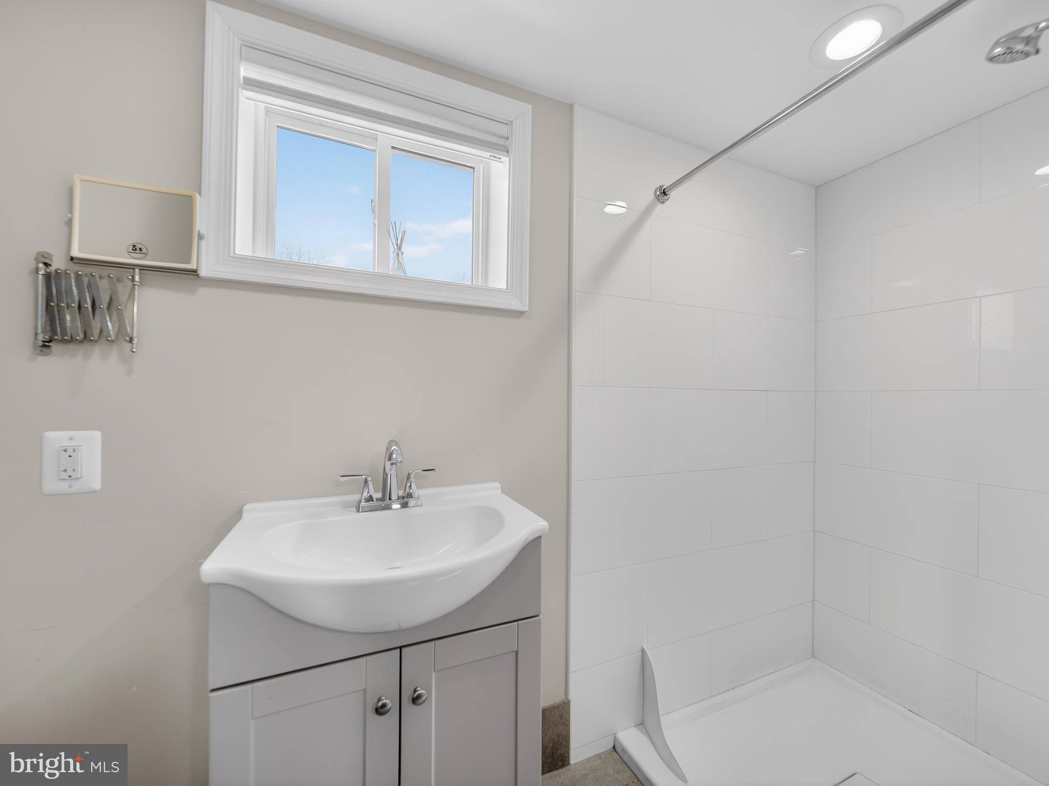 1815 Bonifant Road Silver Spring, MD 20906 - Photo 38 of 49 a bathroom with a sink a toilet and shower