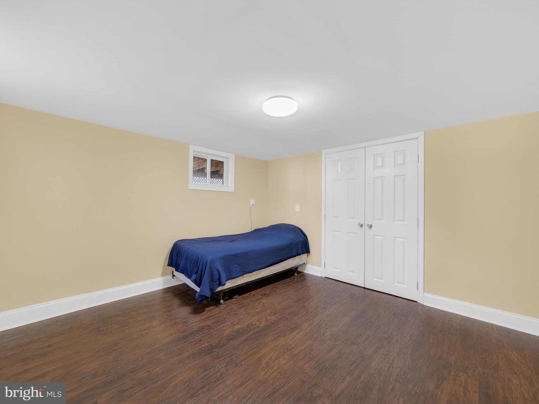 1815 Bonifant Road Silver Spring, MD 20906 - Photo 40 of 49 a bedroom with a bed and wooden floor
