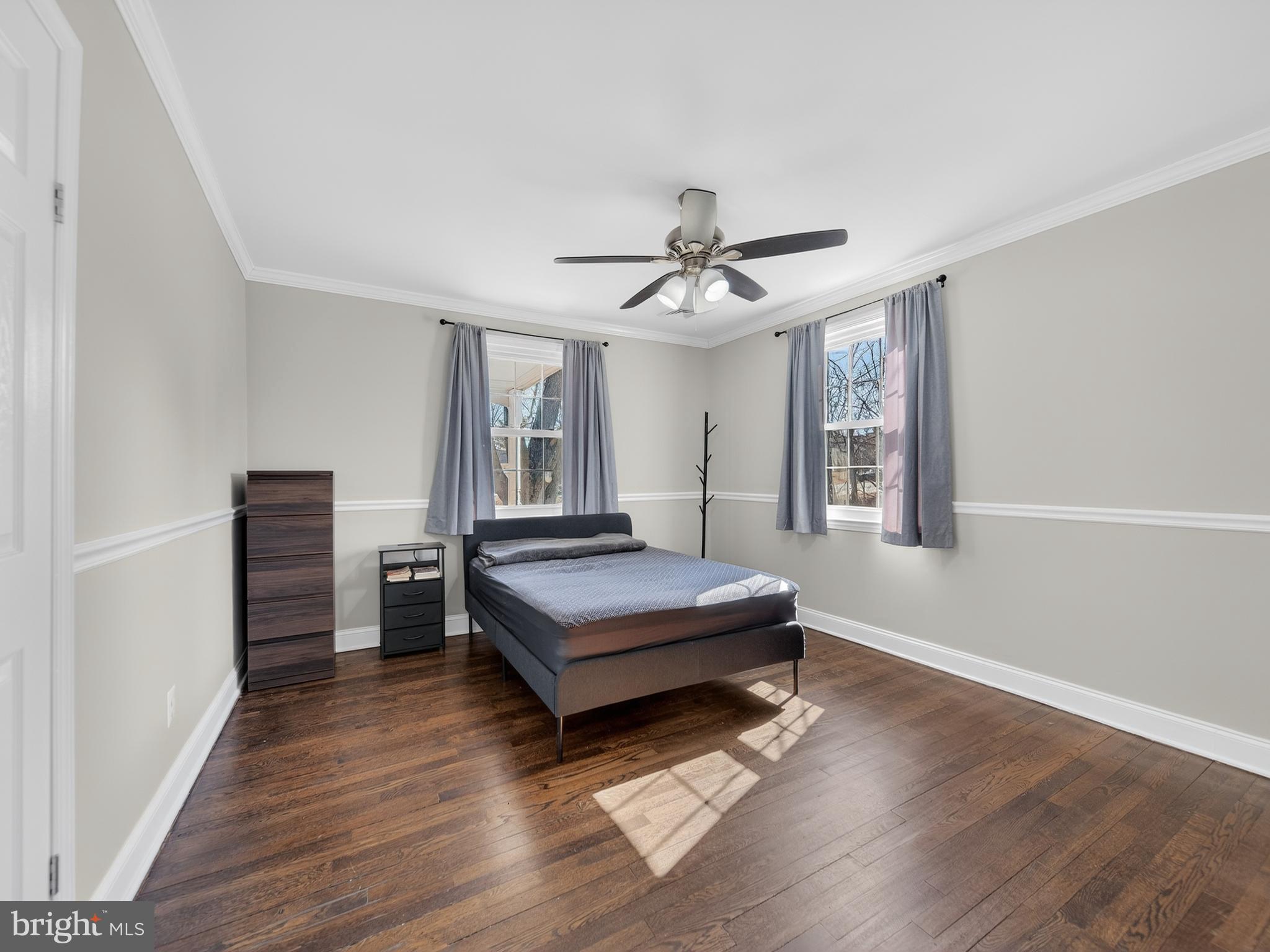 1815 Bonifant Road Silver Spring, MD 20906 - Photo 10 of 49 a spacious bedroom with a bed and a chandelier