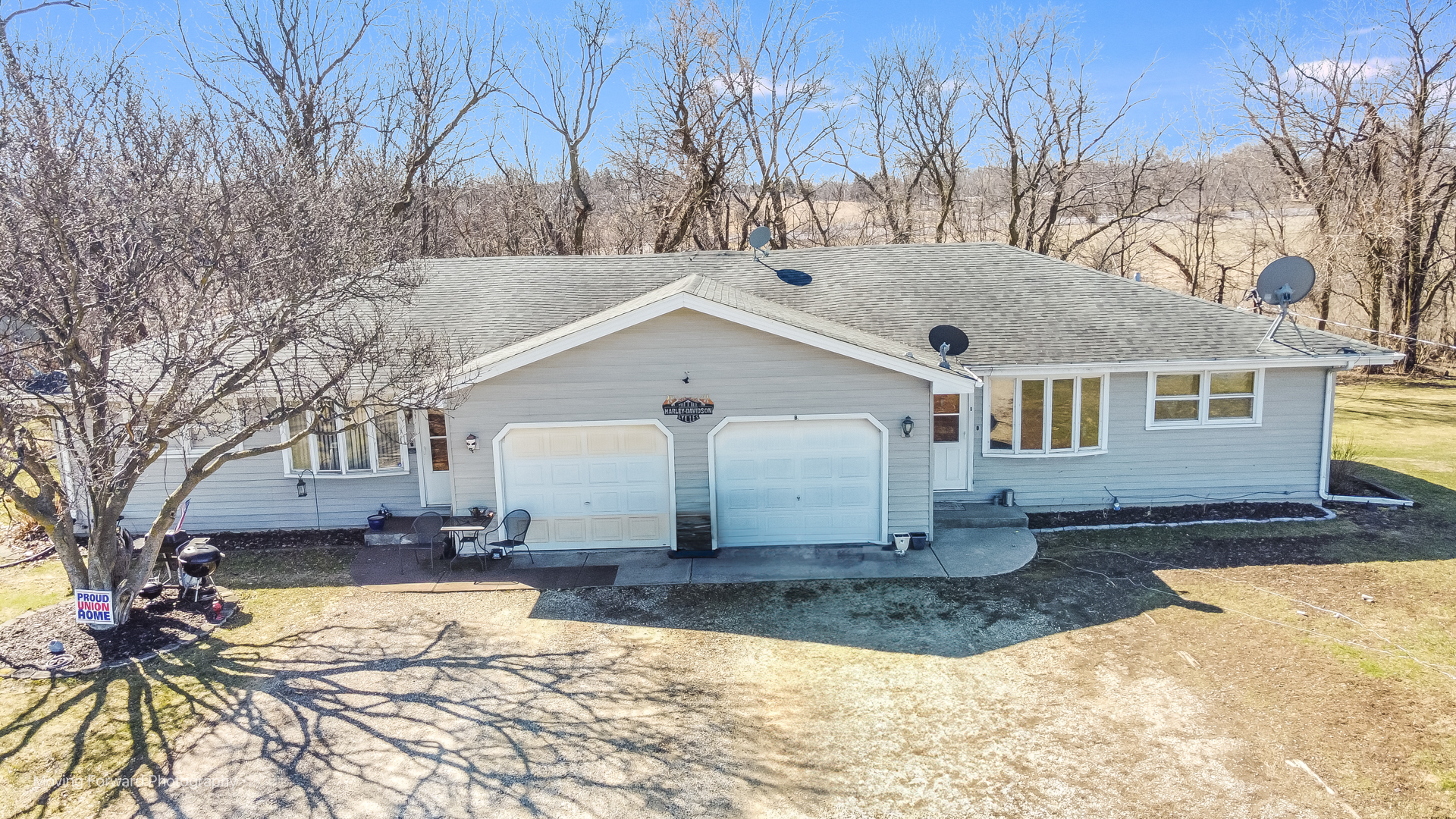 a view of a white house with a yard covered in snow