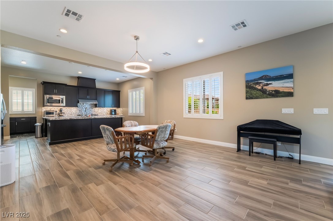 2575 Hazelburn Drive Henderson, NV 89044 - Photo 11 of 65 Dining room featuring light wood finished floors, plenty of natural light, and recessed lighting