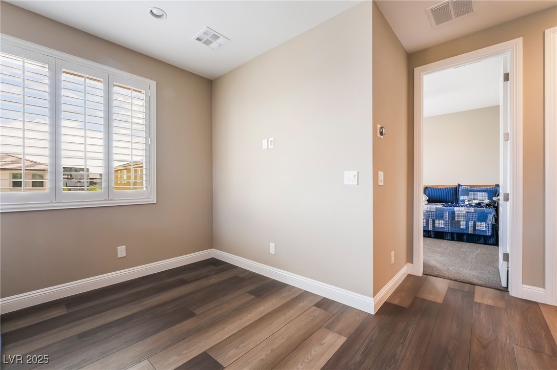 2575 Hazelburn Drive Henderson, NV 89044 - Photo 18 of 65 Unfurnished room featuring dark wood-style floors and recessed lighting