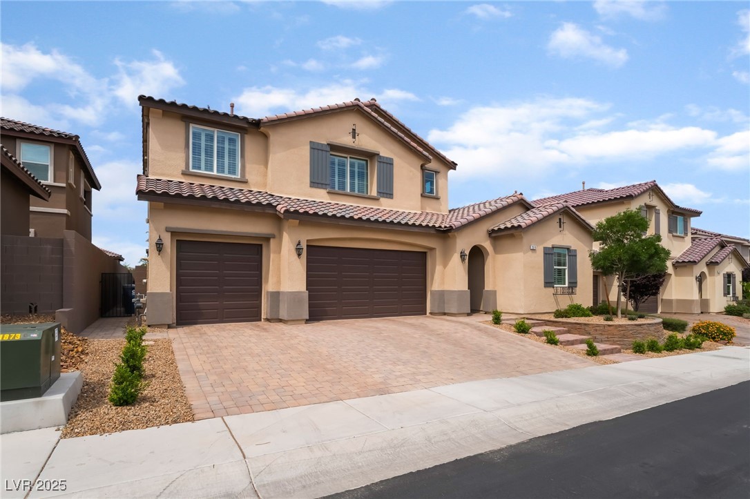 2575 Hazelburn Drive Henderson, NV 89044 - Photo 2 of 65 Mediterranean / spanish house with stucco siding, decorative driveway, an attached garage, and a tile roof