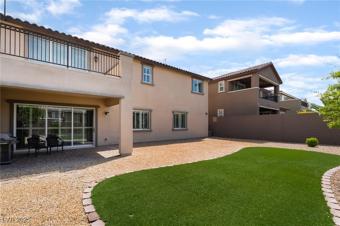 2575 Hazelburn Drive Henderson, NV 89044 - Photo 41 of 65 Back of property with stucco siding and a patio area