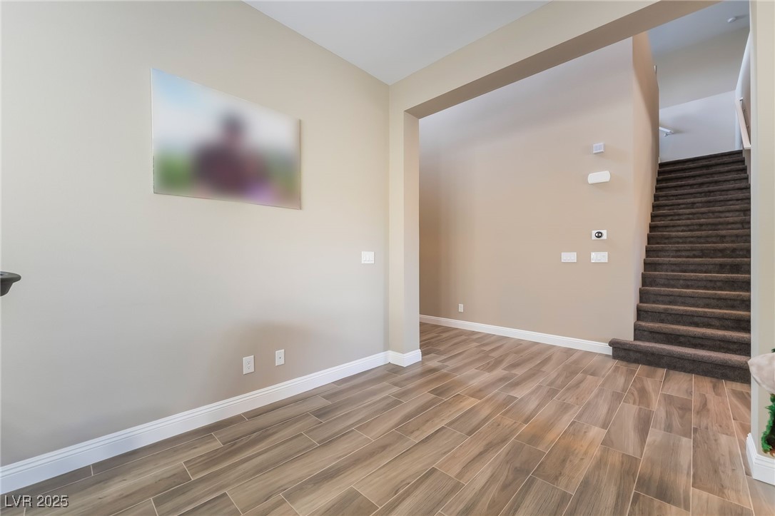 2575 Hazelburn Drive Henderson, NV 89044 - Photo 7 of 65 Unfurnished living room with wood tiled floors and stairs