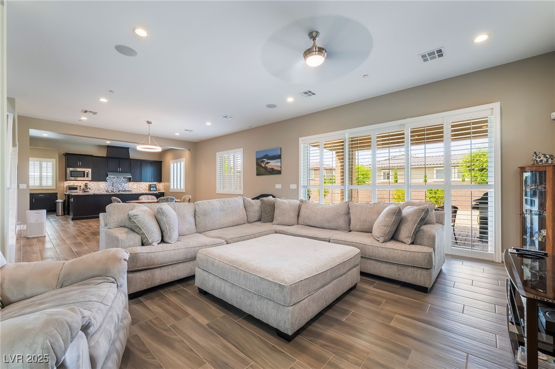 2575 Hazelburn Drive Henderson, NV 89044 - Photo 8 of 65 Living room featuring a ceiling fan, recessed lighting, plenty of natural light, and wood tiled floors