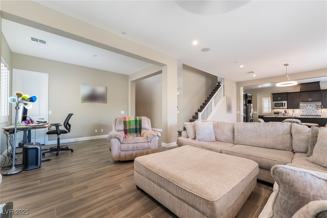 2575 Hazelburn Drive Henderson, NV 89044 - Photo 9 of 65 Living room featuring wood finished floors, stairs, recessed lighting, and a desk
