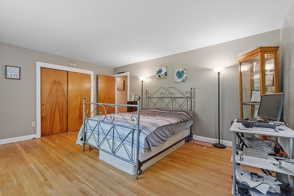 85 Blood Road Charlton, MA 01507 - Photo 17 of 30 a bedroom with a bed and wooden floor