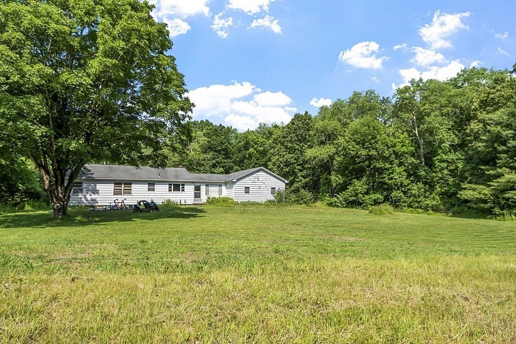 85 Blood Road Charlton, MA 01507 - Photo 3 of 30 a front view of a house with a garden and yard