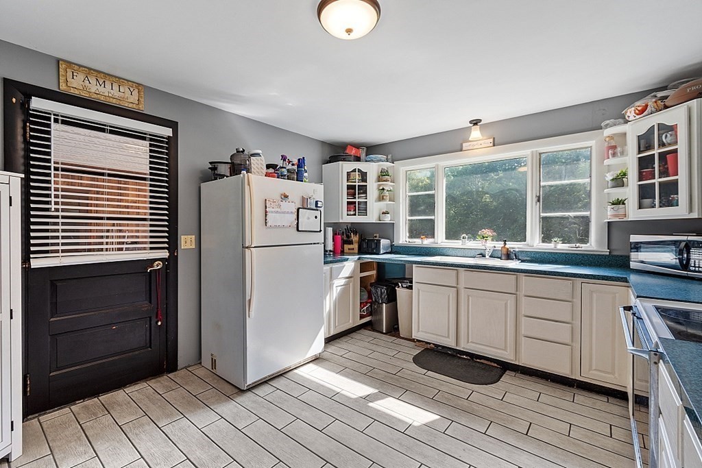 85 Blood Road Charlton, MA 01507 - Photo 9 of 30 a kitchen with granite countertop a refrigerator and a sink
