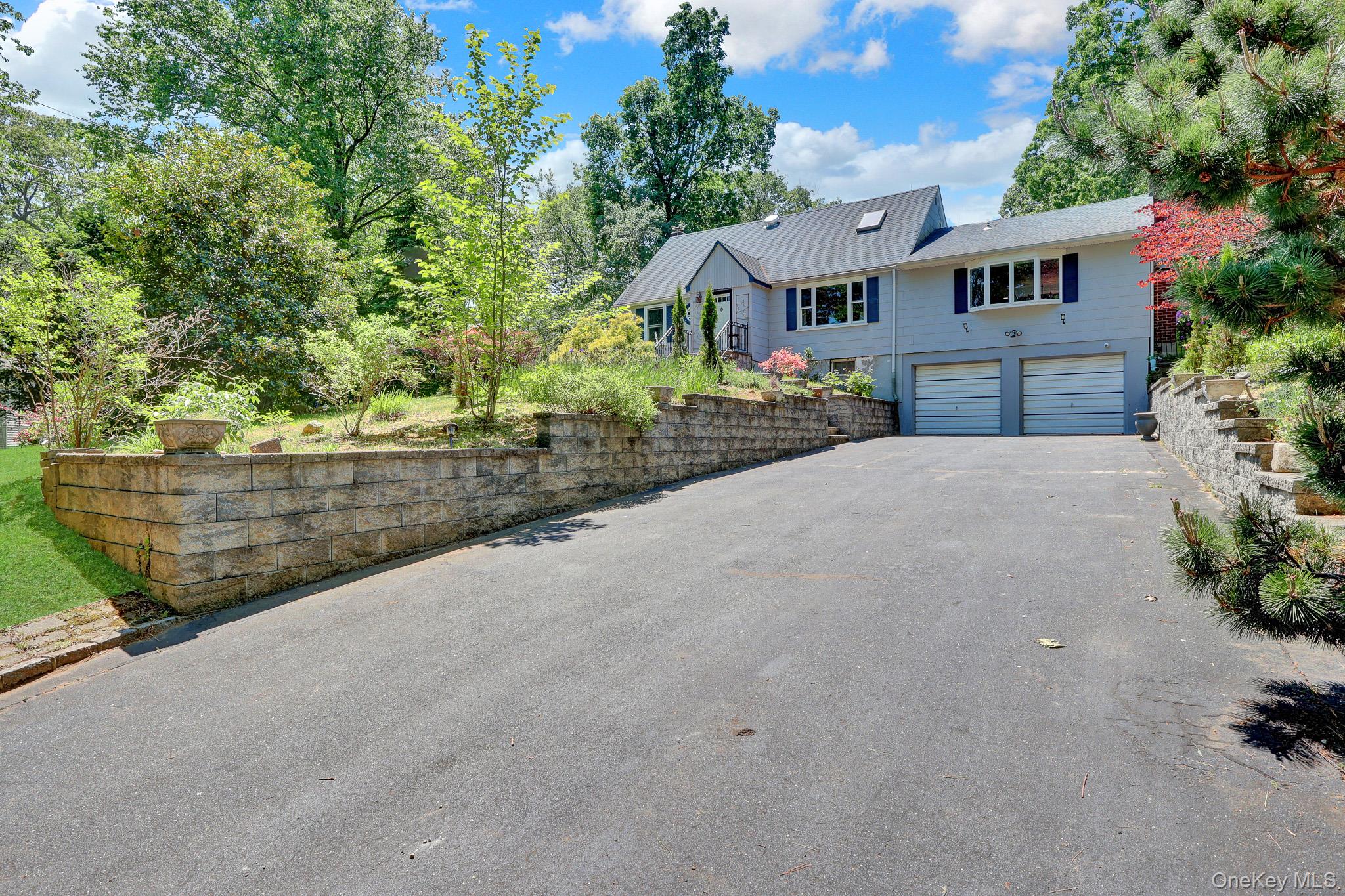 100 Elwood Road Northport, NY 11768 - Photo 3 of 39 Spacious asphalt driveway with two-car garage access