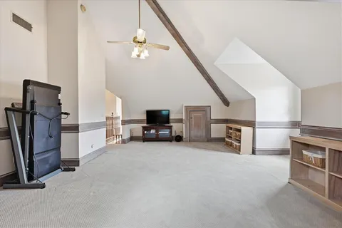 a view of a livingroom with furniture and a ceiling fan