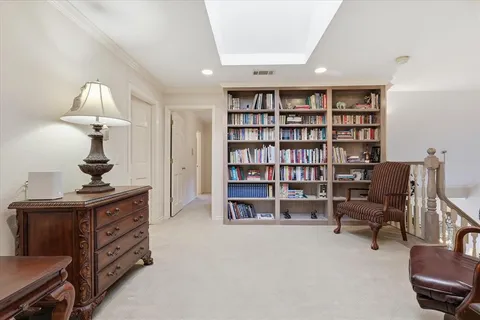 a view of a workspace with furniture and a bookshelf