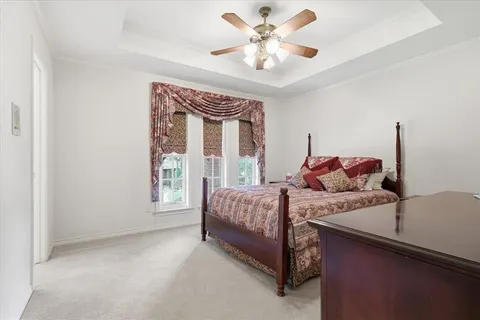 a spacious bedroom with a bed and a chandelier
