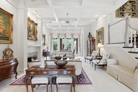 a living room with fireplace furniture and a rug