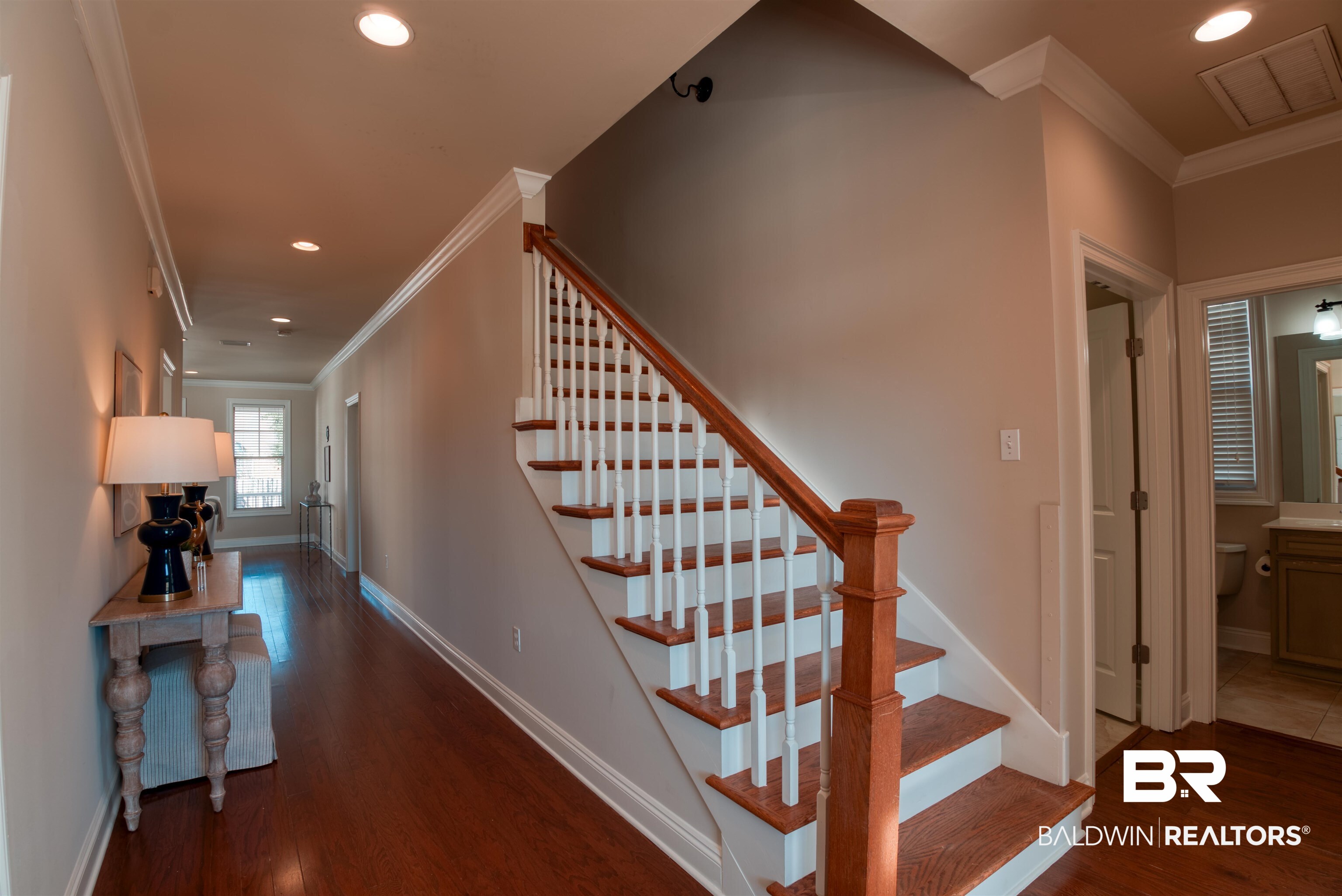 24561 Austin Road Daphne, AL 36526 - Photo 5 of 57 Stairs with hardwood / wood-style floors and ornamental molding