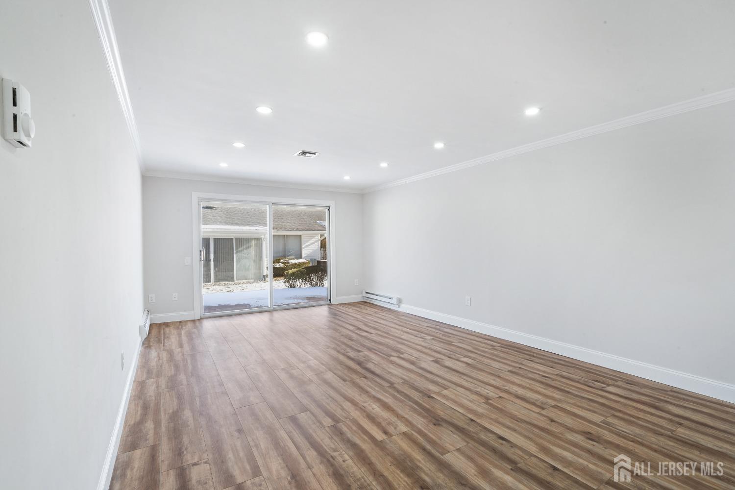 187 Newport Road, Unit A Monroe Township, NJ 08831 - Photo 23 of 26 a view of empty room with wooden floor and fan