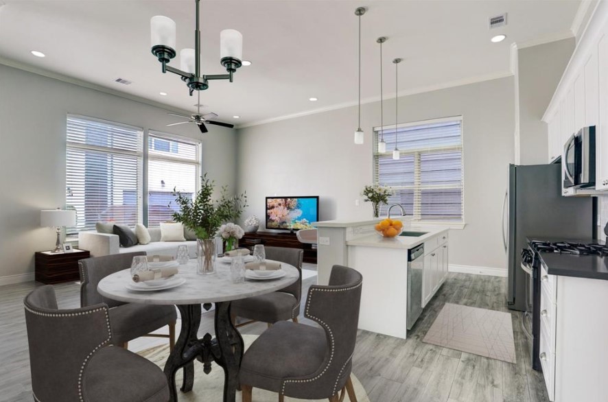 8907 Spring Knoll Forest Drive Houston, TX 77080 - Photo 3 of 21 This dining room rendering leads into the sleek kitchen equipped with stainless steel appliances and a spacious island. Soft, natural light streams through large windows, enhancing the minimalist decor and creating a warm, inviting atmosphere.