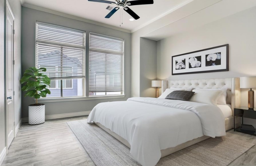 8907 Spring Knoll Forest Drive Houston, TX 77080 - Photo 4 of 21 Primary bedroom rendering. Large windows allow ample natural light, while the potted plant and understated artwork add subtle touches of color and personality to the space.