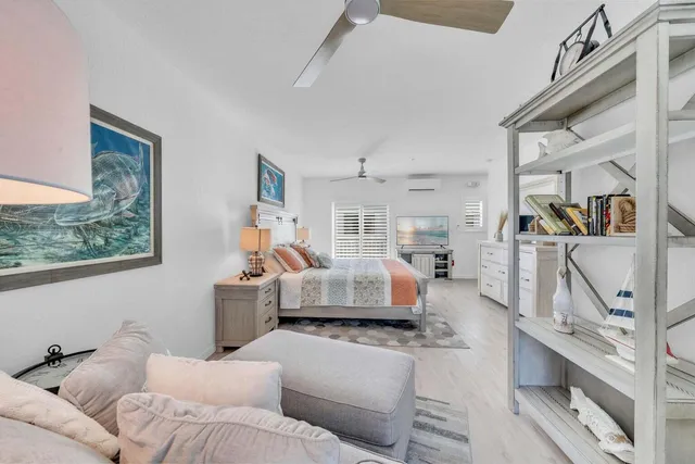 a bedroom with a bed and a view of kitchen