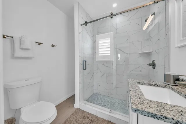 a bathroom with a sink toilet and shower