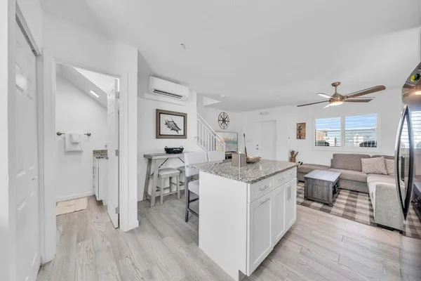 a kitchen with granite countertop a sink stove and refrigerator