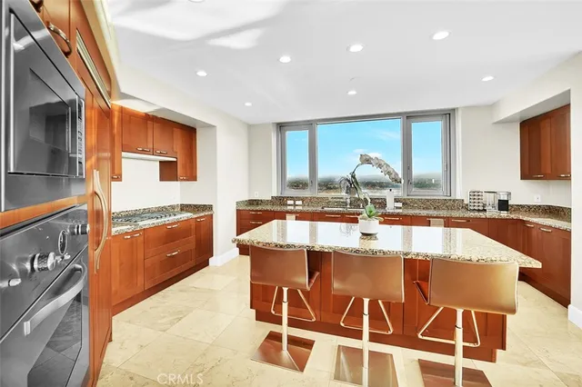 a large kitchen with granite countertop lots of counter top space