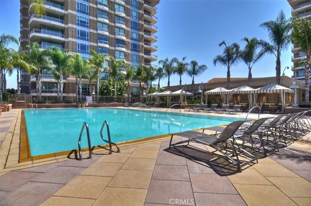 a view of a swimming pool with chairs and potted plants