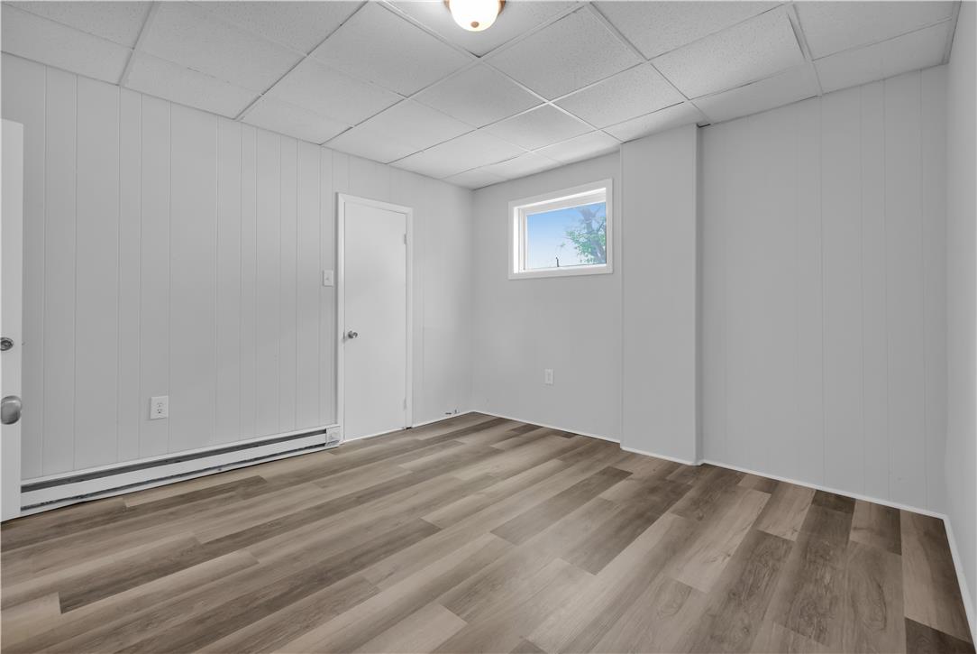 149 West Ridge Street, Unit 2A Lansford, PA 18232 - Photo 6 of 14 Clean wood-look plank flooring anchors this versatile finished lower-level space.