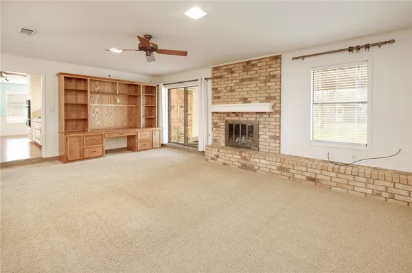 an empty room with furniture and windows