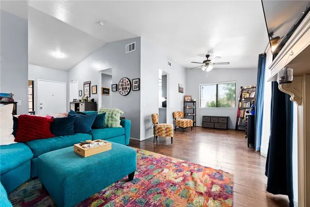 a living room with furniture and a view of kitchen
