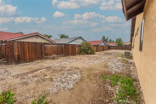 a view of a house with wooden fence