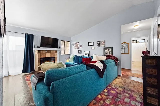 a bedroom with a bed a fireplace and a television