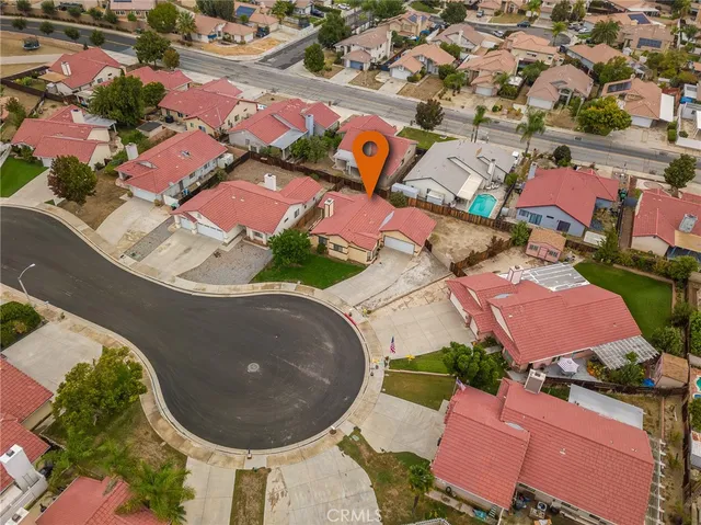an aerial view of a house with a swimming pool and outdoor seating