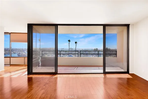 an empty room with sliding glass door and mountain view