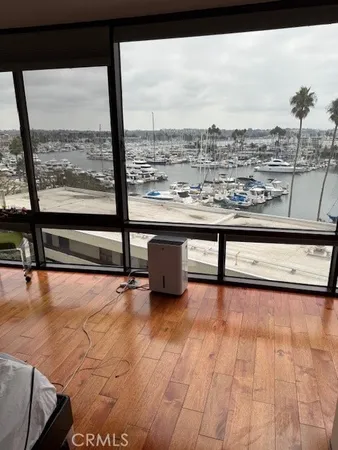 a view of a living room with furniture and a floor to ceiling window