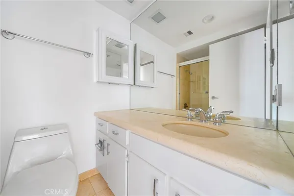 a bathroom with a sink toilet vanity and shower