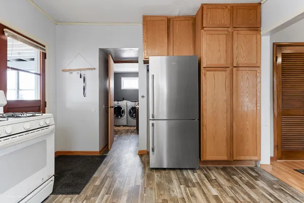 a kitchen with stainless steel appliances a refrigerator and a stove top oven